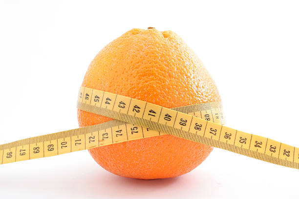 Yellow measure tape and orange - isolated
