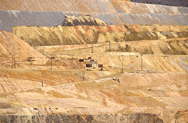 istock Road and telephone poles in open pit copper mine 183242768