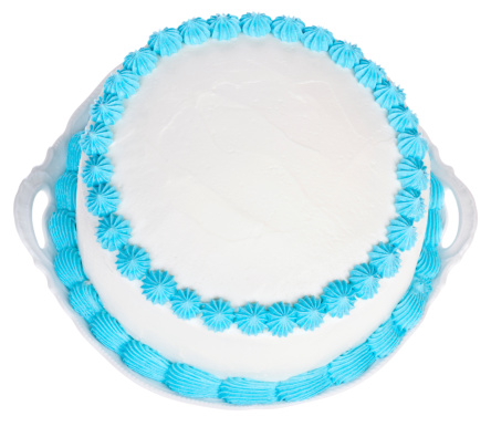 Homemade birthday or party cake frosted with white icing and decorated with sky blue colored details. The top of the cake is plain white so you can personalize it.