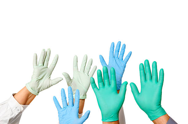 Hands with doctor rubber gloves in green, blue, and white Many doctors hands in gloves, isolated on white. surgical glove stock pictures, royalty-free photos & images