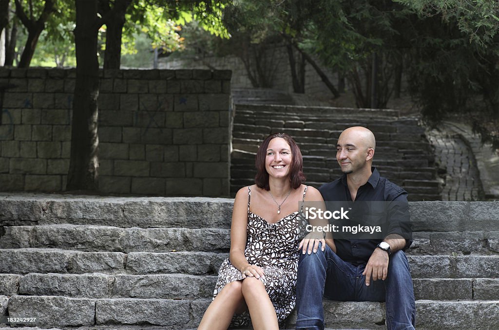 Romance At The Park Happy young couple sitting on the staircase at the park. 30-34 Years Stock Photo