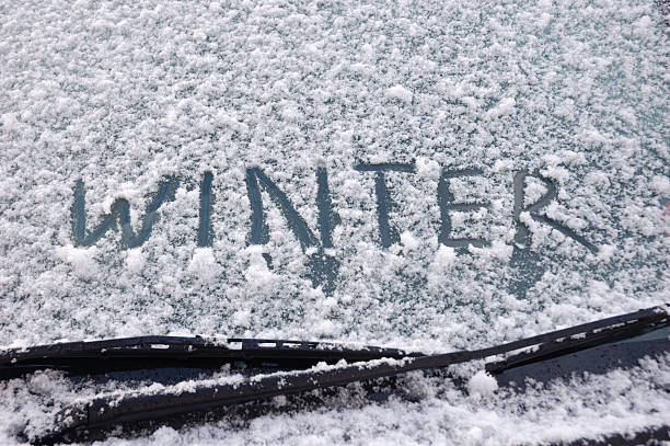 Winter written on a snow covered window stock photo