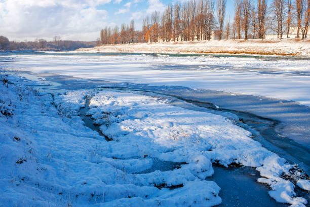 istock urban landscape with frozen river 1832429936