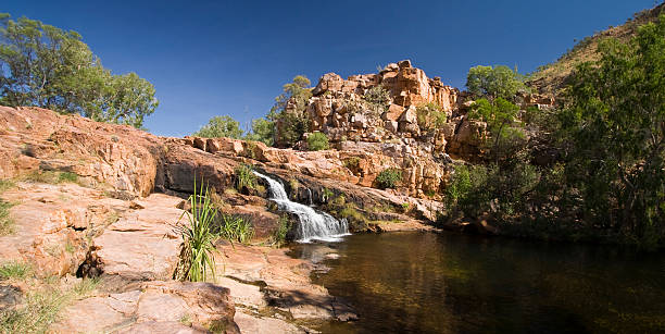Champagne Springs A picturesque waterfall cascading from Champagne Pools on remote El Questro Station in Western Australia's Kimberley region kimberley plain stock pictures, royalty-free photos & images