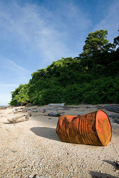 istock Stranded oil drum at tropical beach 183243447