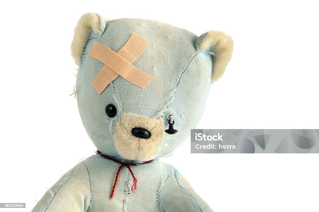 old damaged teddy bear with adhesive bandage "old DDR republic toy from 1970. originally it came with a Plush pell, but its all taken off. old damaged teddy beer with adhesive bandage and hanging eye. dirty teddy bear" Teddy Bear Stock Photo