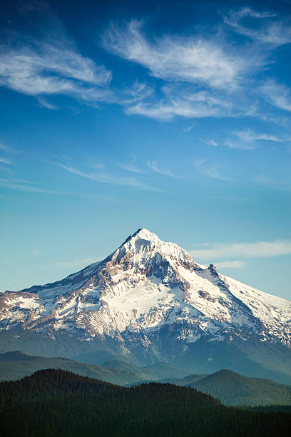 Mount Hood, Oregon State A scenic view of Mt. Hood, and the surrounding hills, a gorgeous cloudscape and blue sky overhead.  One of the many beautiful mountains in the Pacific Northwest.  Vertical with copy space. mt hood photos stock pictures, royalty-free photos & images