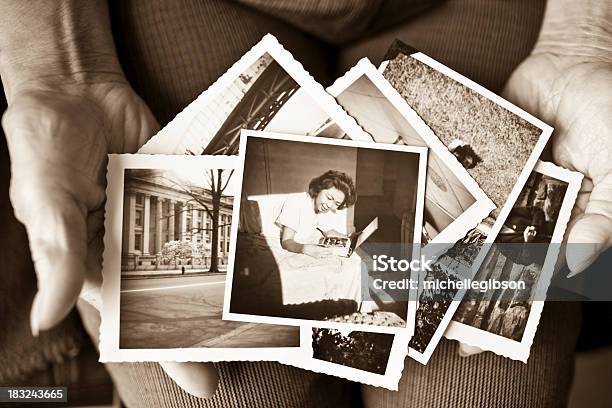 Elderly Woman Holding A Collection Of Old Photographs Stock Photo - Download Image Now