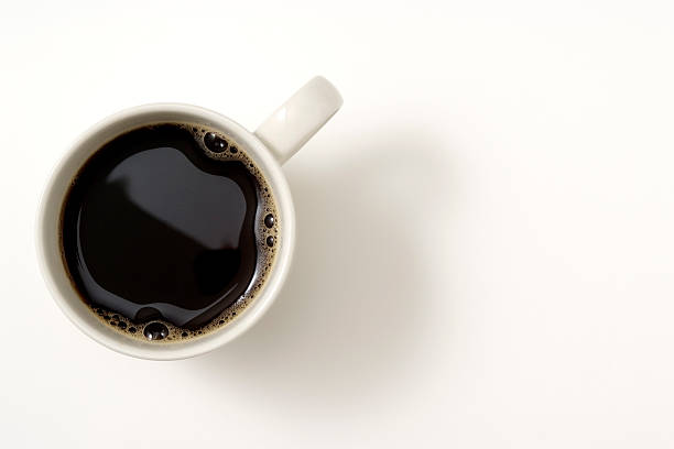 Isolated shot of a cup of coffee on white background Overhead shot of a cup of coffee isolated on white background with soft shadow. above stock pictures, royalty-free photos & images