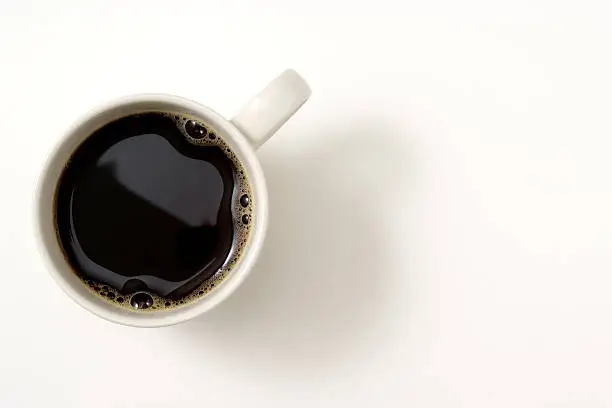 Photo of Isolated shot of a cup of coffee on white background