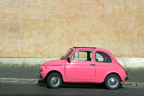 istock Tiny pink vintage car in Rome, Italy 183243889