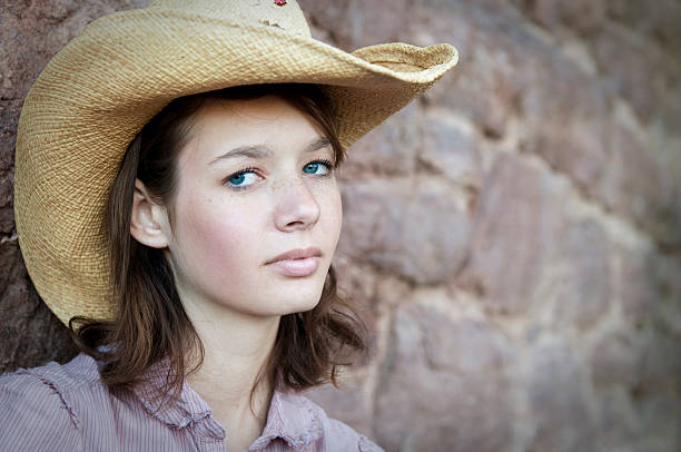 A young teen model wearing a cowboy hat.