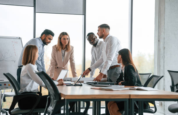 istock In the modern office. Group of workers are together indoors 1832444007