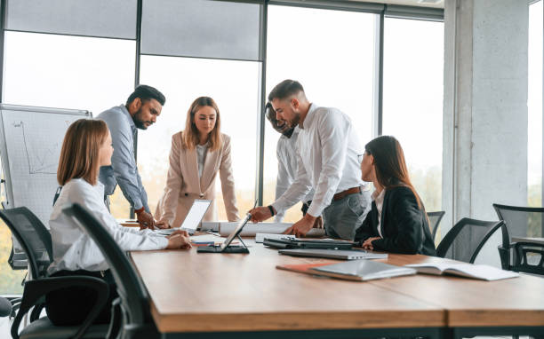 istock In the modern office. Group of workers are together indoors 1832444013