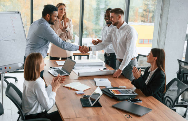 istock Successful agreement, making handshake. Group of office workers are together indoors 1832444544