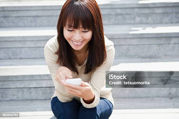 Young Woman Uses The Smartphone Stock Photo - Download Image Now - Adult, Adults Only, Asian and Indian Ethnicities