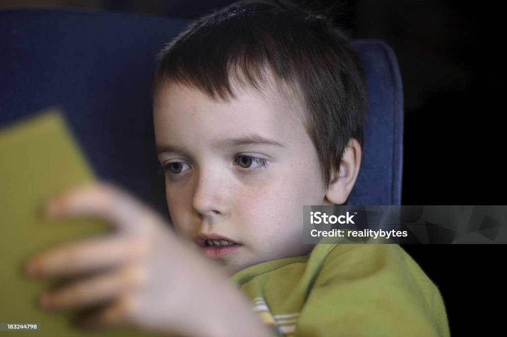 Little Caucasian Boy Learning to Read A young boy reads a book. Book Stock Photo