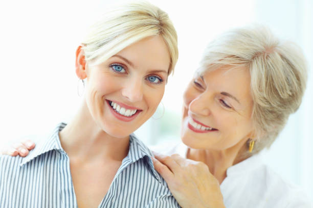 istock Smiling young woman with mother against white background 183244867