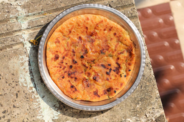 Aloo paratha or gobi paratha also known as Potato or Cauliflower stuffed flatbread dish. potato stuffed flat bread. North Indian famous food Aloo Paratha in isolated white background.