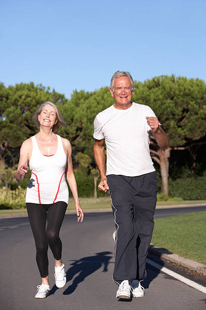 istock Senior Couple Running On Road 183245361