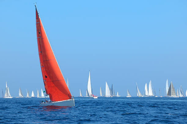 Boat with red sail Sailboats during a regatta.  French Riviera regatta stock pictures, royalty-free photos & images