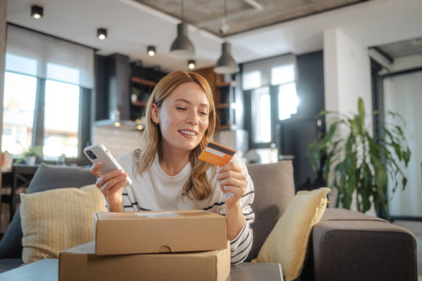 istock Beautiful woman using online services for e-commerce at home 1832466341