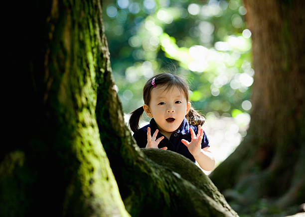 Little girl playing in a park stock photo