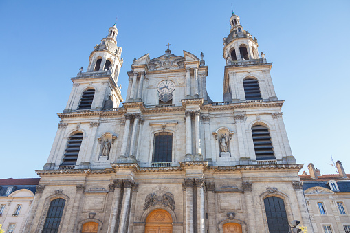 The facade of a Catholic church in Lisbon, Portugal, displays intricate architectural details, featuring ornate stonework, grand arches, and a towering entrance adorned with religious symbolism, exuding a sense of grandeur and spirituality.