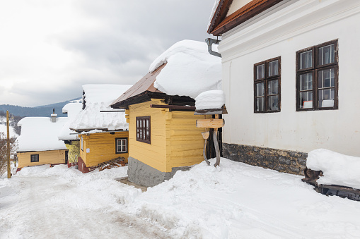 Folk architecture in snowy winter landscape. Vlkolinec village with historical colorfull wooden houses, Slovakia Europe.