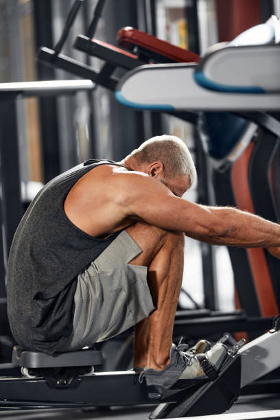 istock Training legs in the simulator, the athlete works with his legs on the simulator, working out the muscles on the legs 1832475419