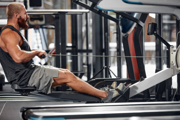 istock Training legs in the simulator, the athlete works with his legs on the simulator, working out the muscles on the legs 1832475937