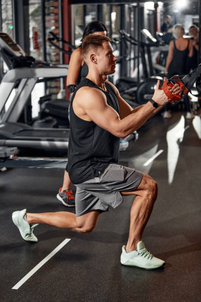 istock A man trains his arms and chest in the gym on the simulator, does exercises for different muscle groups. Fintes motivation, sports lifestyle, health, athletic body, body positive. Film grain. 1832476028