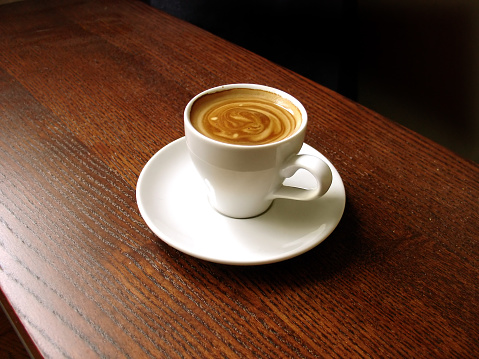 cup of espresso on a wooden bar