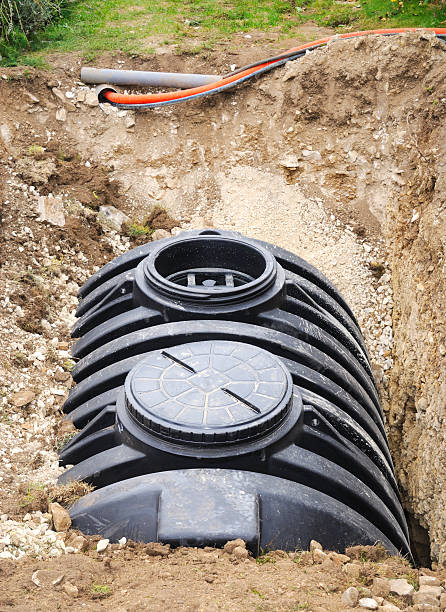 Installation of a Septic Tank Installation of a drainage tank (septic tank) showing diverted pipework. 4000 litre capacity. burying stock pictures, royalty-free photos & images