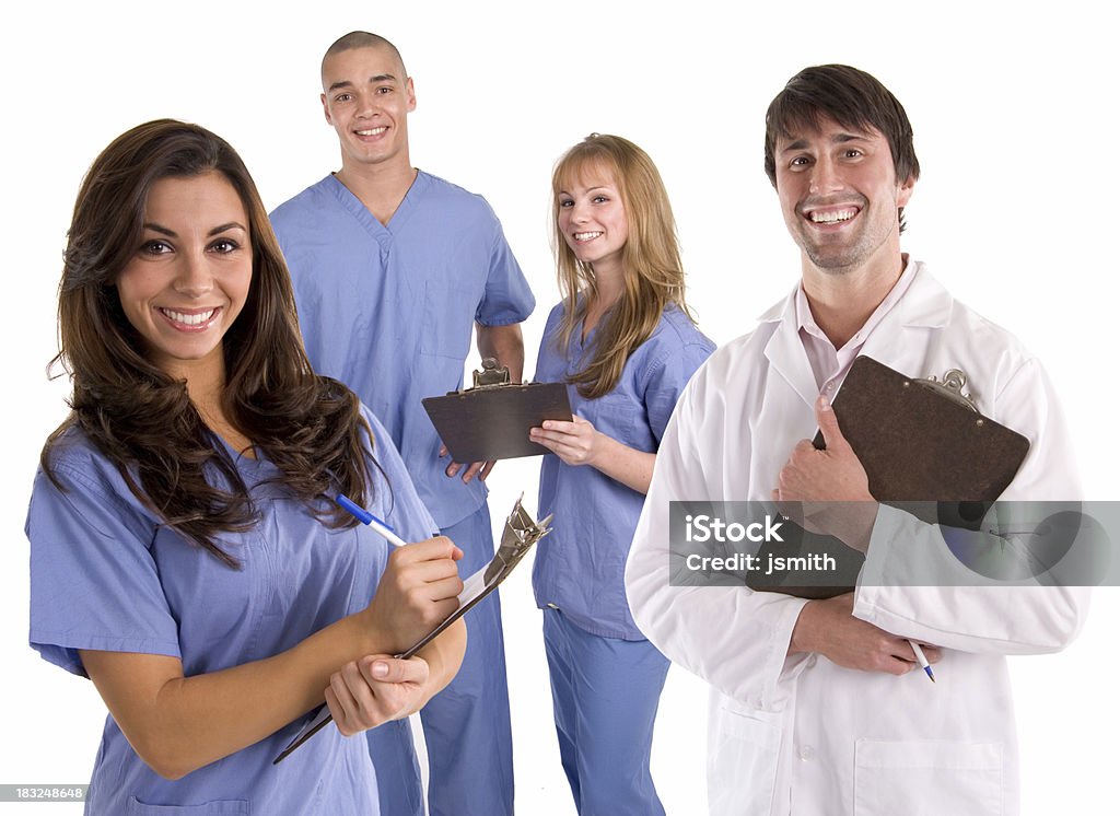 Medical Team 3 "Doctor, male and female nurses stand with clipboards on rounds while smiling in their scrubs and white lab coat" Nursing Assistant Stock Photo