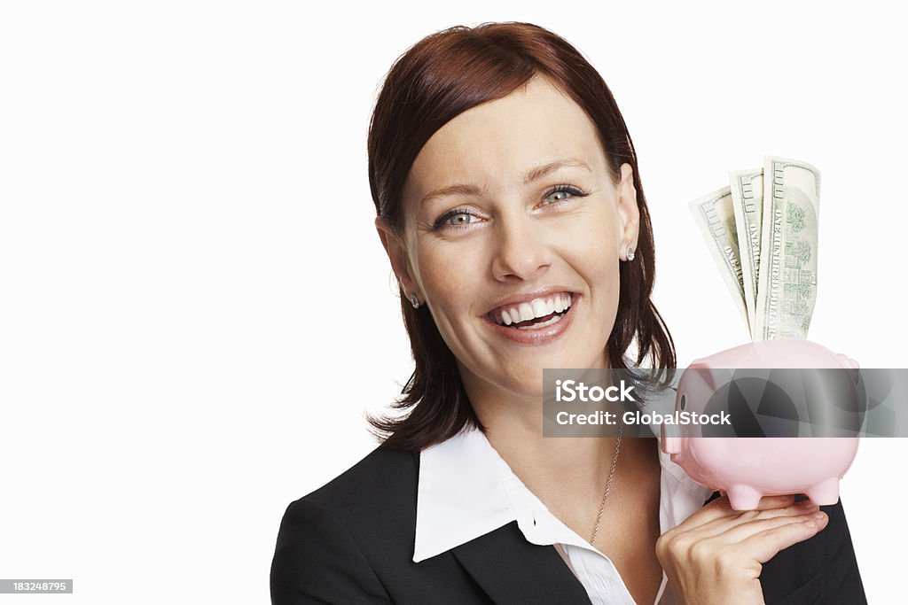 Smiling business woman holding piggy bank Portrait of a smiling business woman holding piggy bank against white Administrator Stock Photo