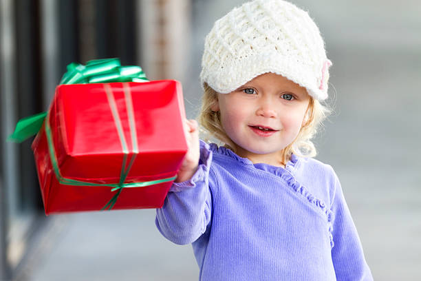 istock Little Girl Holding a Gift 183249092