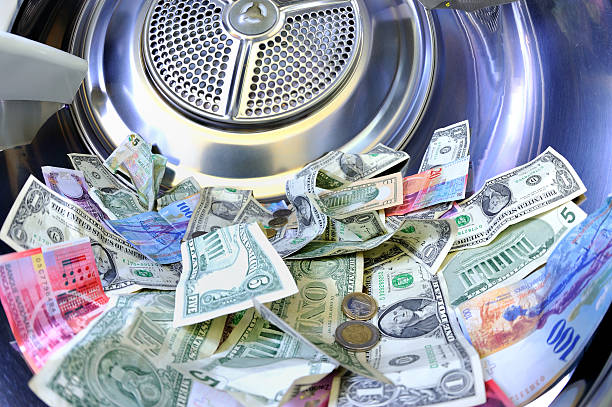 Paper bills on several currency inside a washing machine concept image of money laundering money laundering stock pictures, royalty-free photos & images