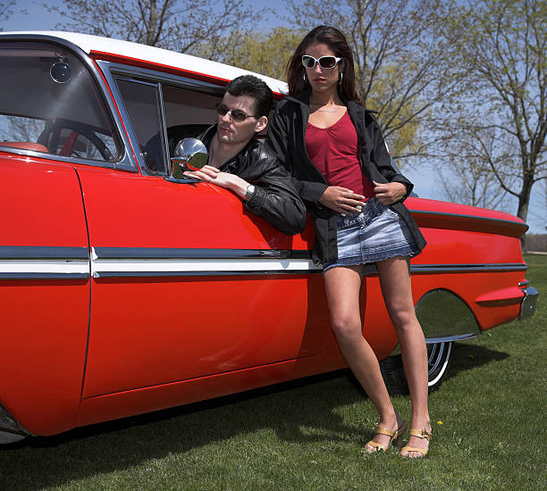istock classic car with young man and woman 183249345