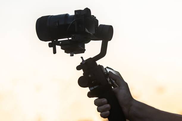 istock A man operating camera mounted on a gimbal, focus on the gimbal and camera 1832495664