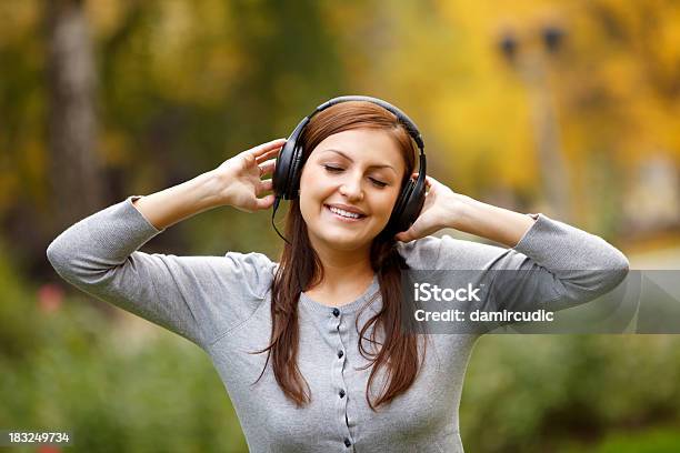 Young Woman Listening To Music In Nature Stock Photo - Download Image Now - 20-24 Years, Adult, Adults Only