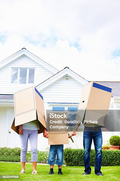 Family Cover Their Faces With Boxes In Front Of House Stock Photo - Download Image Now