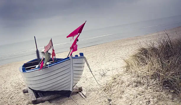 Small fishing boat on the beach of Zinnowitz (Baltic Sea ) in grey november