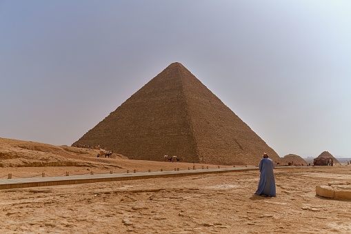 The Pyramid of Khafre, Giza Necropolis, Egypt - July 26, 2022: The pyramid of Khafre or of Chephren is the second-tallest and second-largest of the 3 Ancient Egyptian Pyramids of Giza and the tomb of the Fourth-Dynasty pharaoh Khafre (Chefren), who ruled c. 2558−2532 BC.\n\nThe pyramid has a base length of 215.5  m (706 ft) and rises up to a height of 136.4 metres (448 ft). It is made of limestone blocks weighing more than 2 tons each. The slope of the pyramid rises at a 53° 13' angle, steeper than its neighbor, the pyramid of Khufu, which has an angle of 51°50'24\