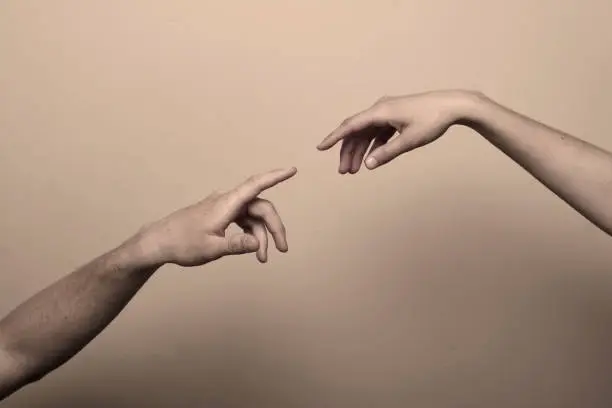 "two hands reaching out, their fingers about to touch.  grain added.  inspired by michelangelo's painting ""The Creation of Adam"""