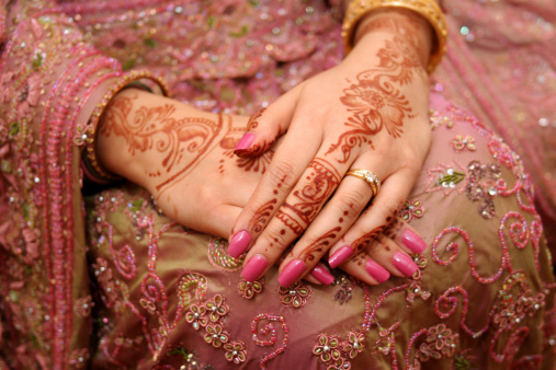 An Asian bride's hands decorated with henna on her wedding day.  Henna by Asma Meer.