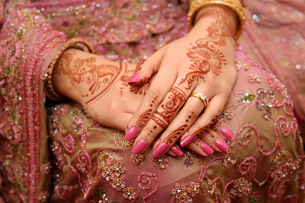 An Asian bride's hands decorated with henna on her wedding day.  Henna by Asma Meer.