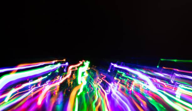 istock Beautiful abstract wallpaper with vibrant, colorful lights against a deep, black background 1832509593