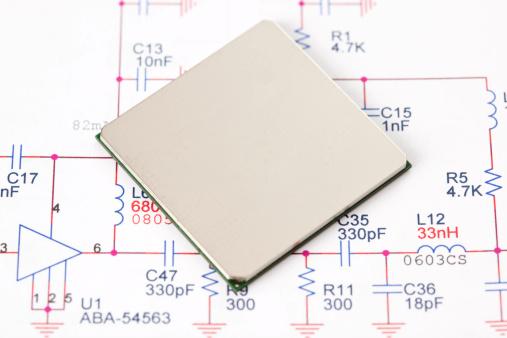 Integrated Circuit IC Chip on electronic scheme background.