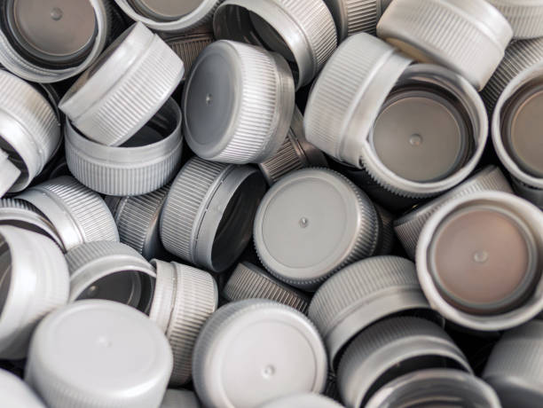 istock Top view grey plastic bottle caps.Recycling collection and production processing plastic bottle caps background 1832511427
